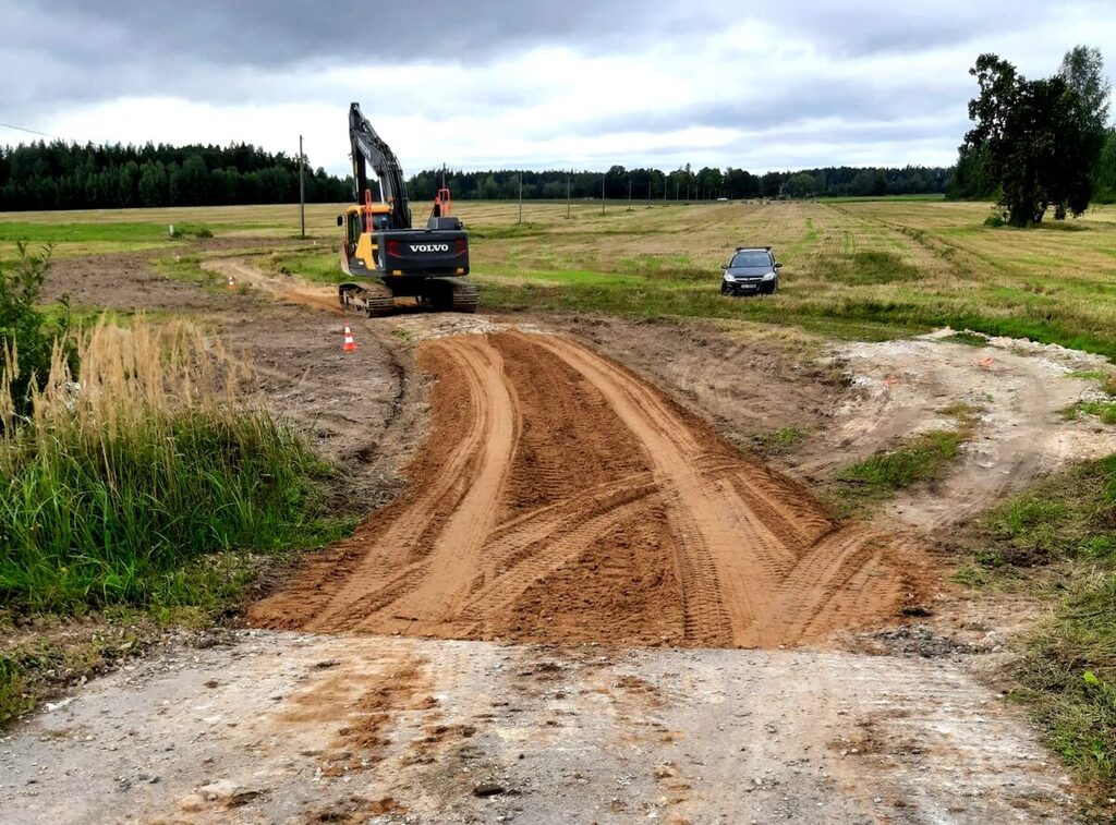 "Valmieras ceļi" ekskavators strādā pie grants ceļa būvniecības lauka Vidzemē