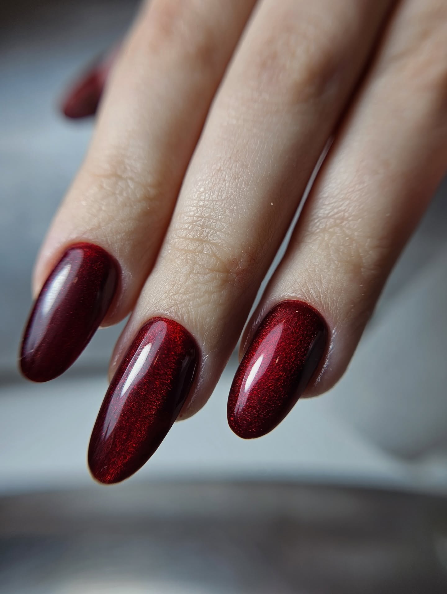 Tumši sarkans cat eye manikīrs